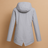 Long waterproof raincoat for women with hood and breathable fabric, available in apricot, blue, coffee, gray, white, and wine red.