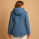 Long waterproof raincoat for women with hood and breathable fabric, available in apricot, blue, coffee, gray, white, and wine red.